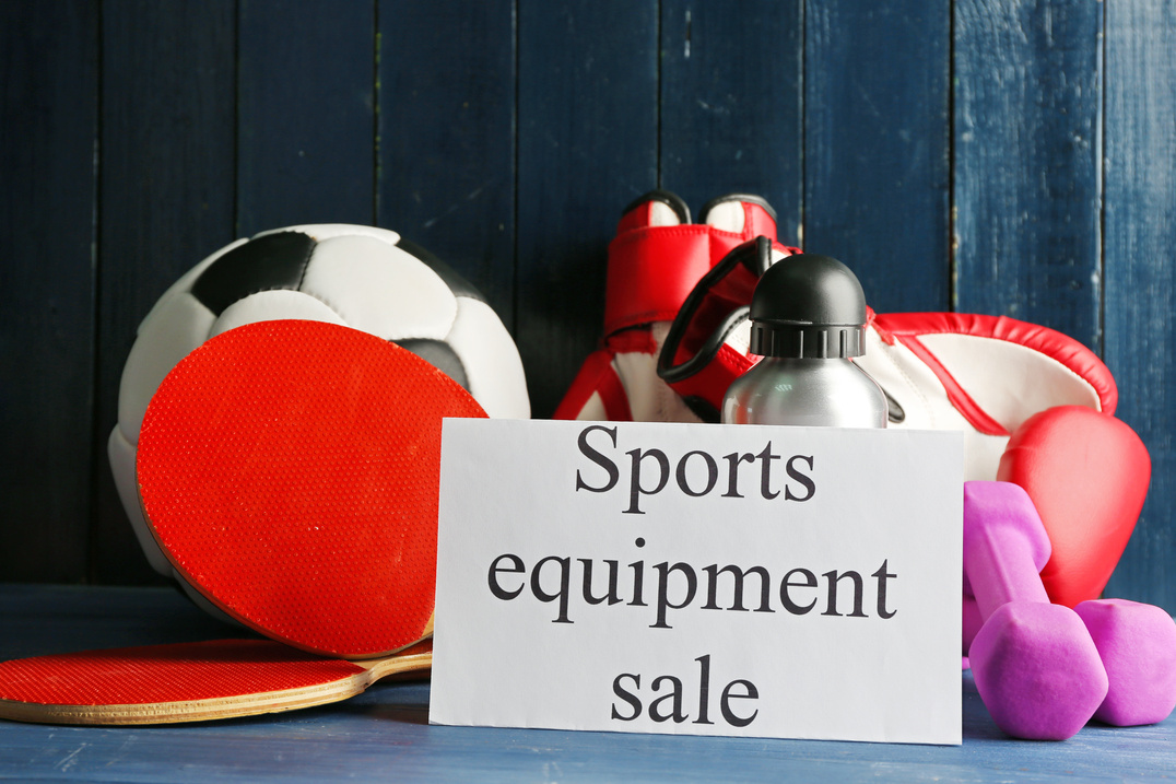 Sport Goods for Sale on Wooden Wall Background 